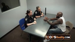 Black criminal is being interrogate by two stunning and horny MILFs.